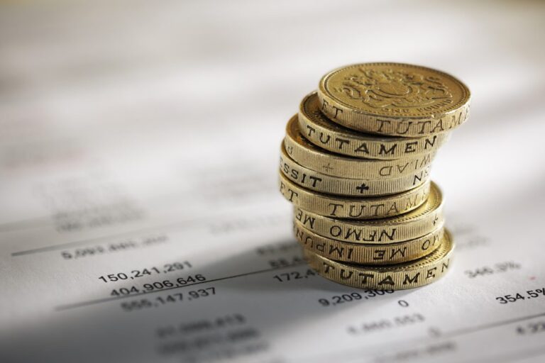 Stack,Of,Pound,Coins,On,Financial,Figures,Balance,Sheet