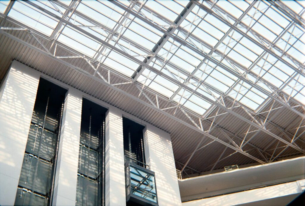 Glass lifts beneath a skylight roof